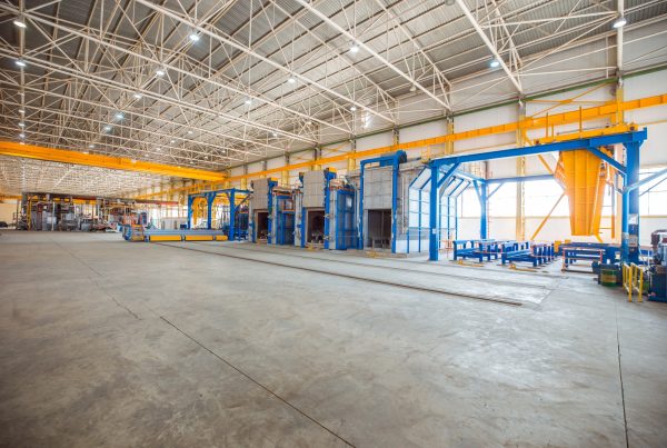 metallic ovens inside big factory with heavy equipments
